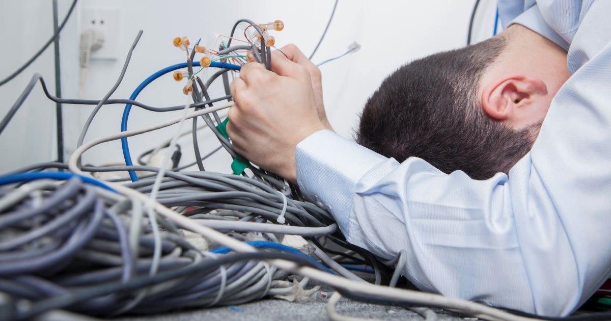 A guy trying to sort computer cable mess